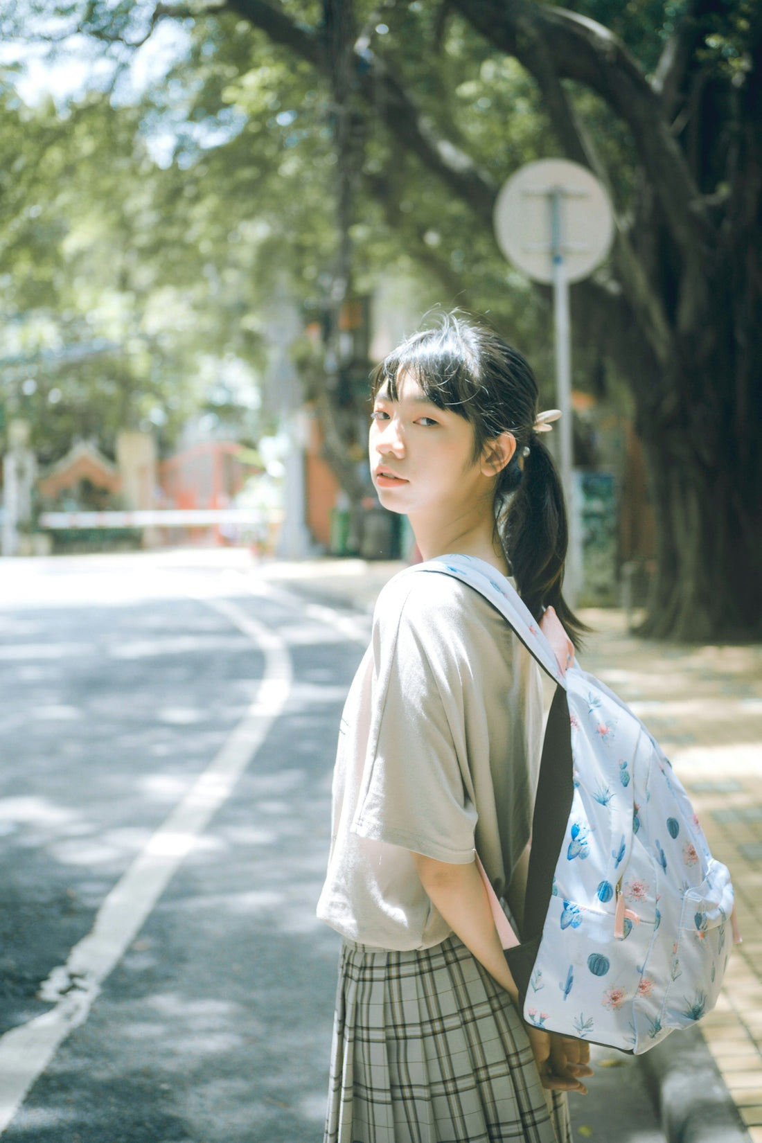 woman standing beside road