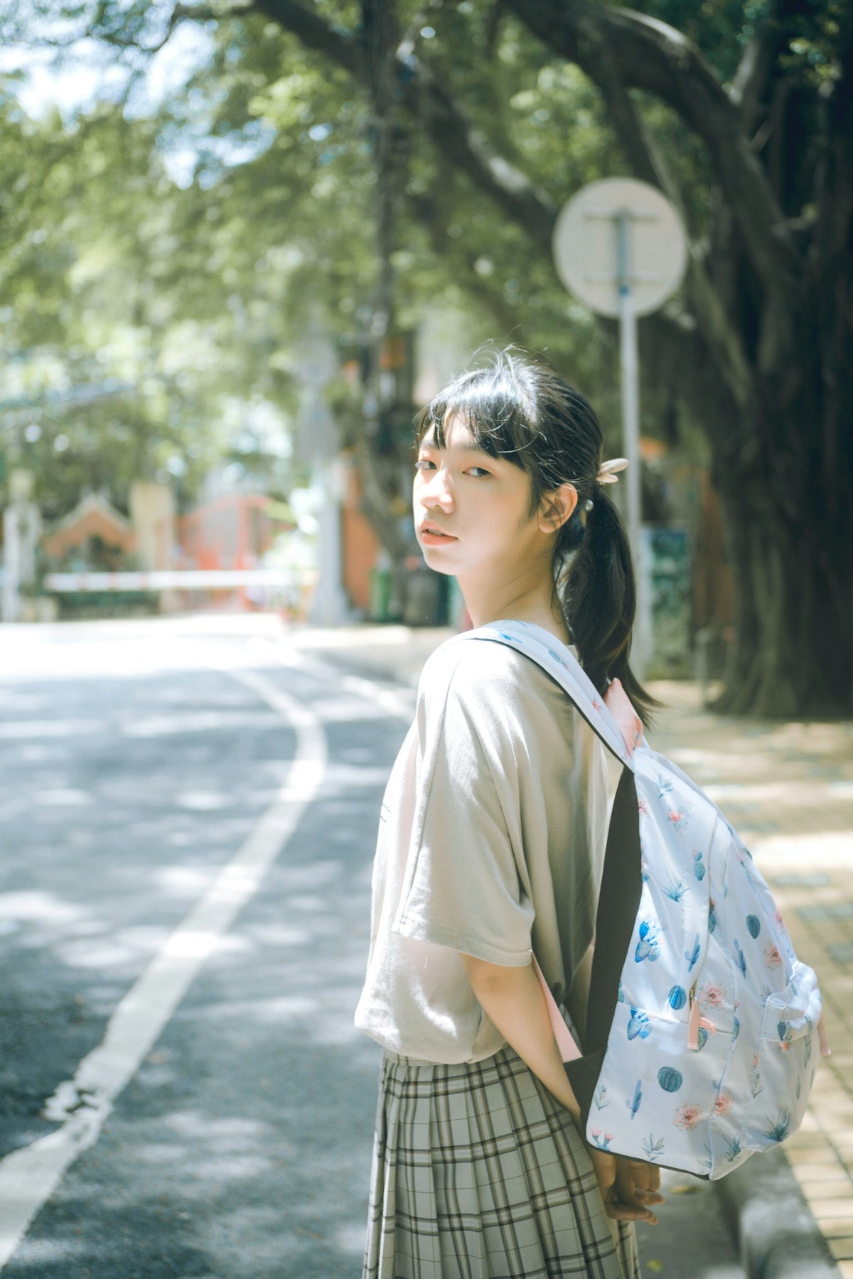 woman standing beside road