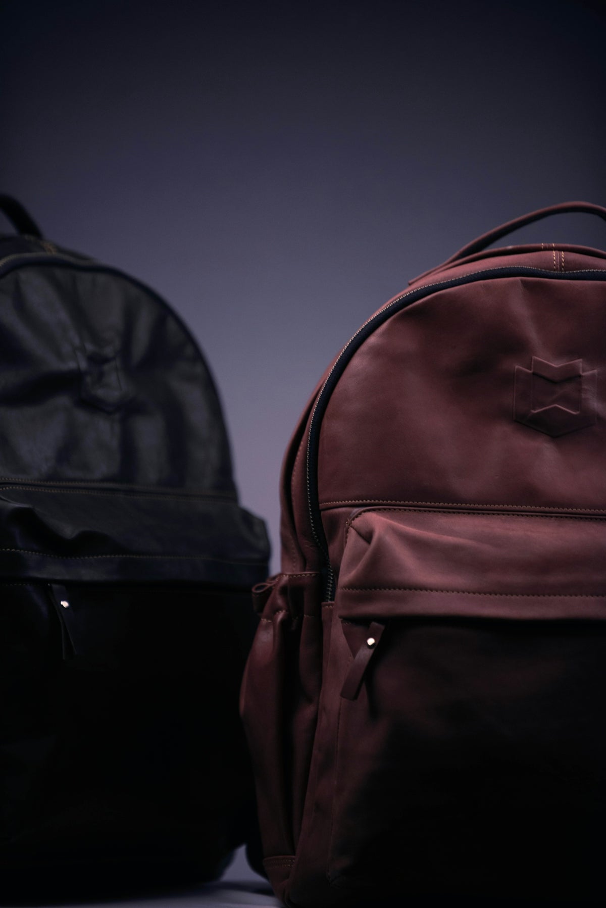 black and brown backpack on black surface